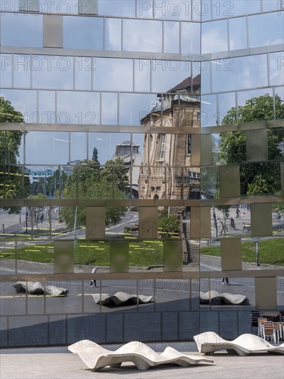 The building of the university library and the reflection on the glass facade of the building