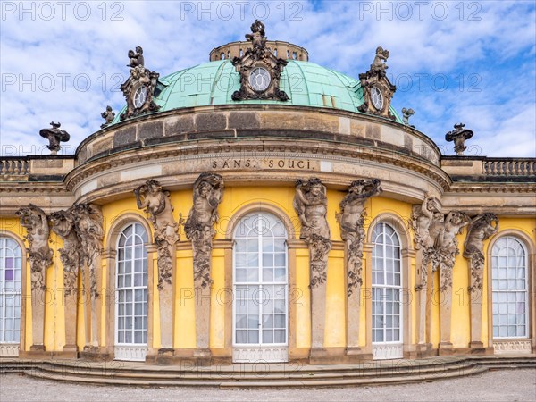Detail of the yellow building of Sanssouci Palace with semi-oval central building