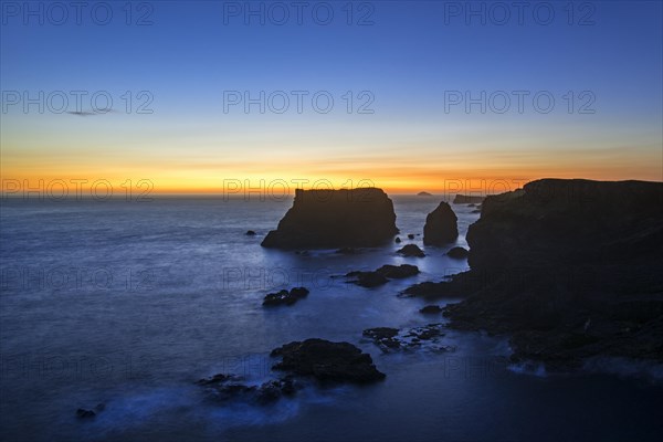 Sea stacks and cliffs at sunset at Eshaness