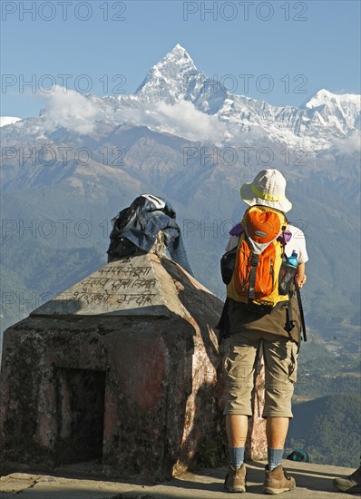 A Nepalese hiker looks at the Annapurna mountain range in the Himalayas from Sarangkot