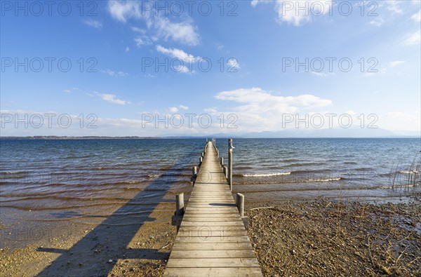 Footbridge on the lake under a blue sky