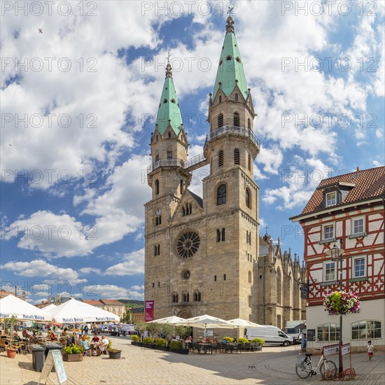 Cafes at the market with the town church of Our Lady