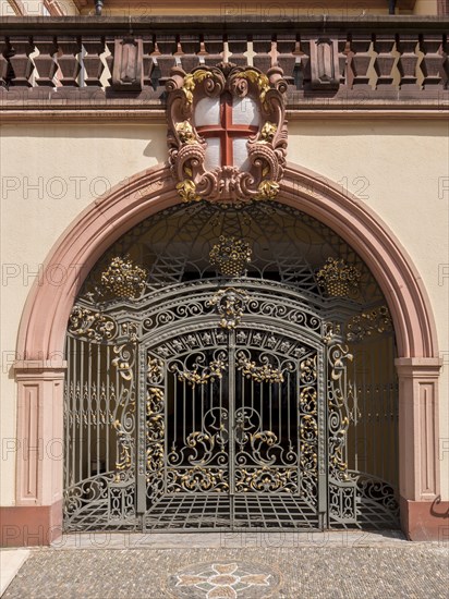 Entrance to a house with iron door and coat of arms above it in the centre of the old town