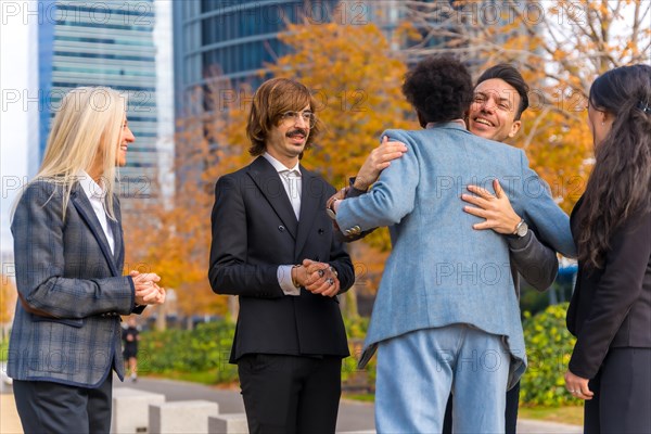 Middle-aged multi-ethnic businessmen and businesswomen shaking hands in good working environment