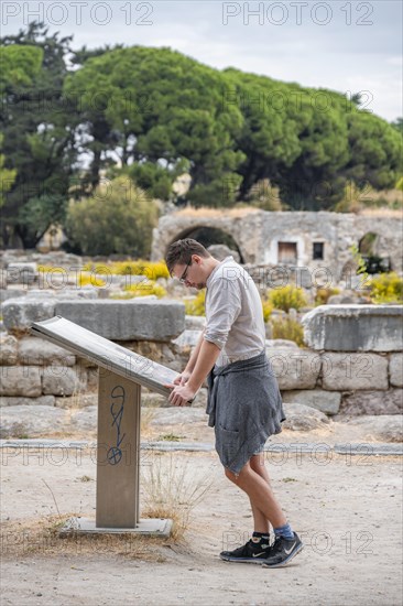 Man reading information board