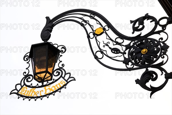 Wrought-iron lamp with nose shield at Luther House