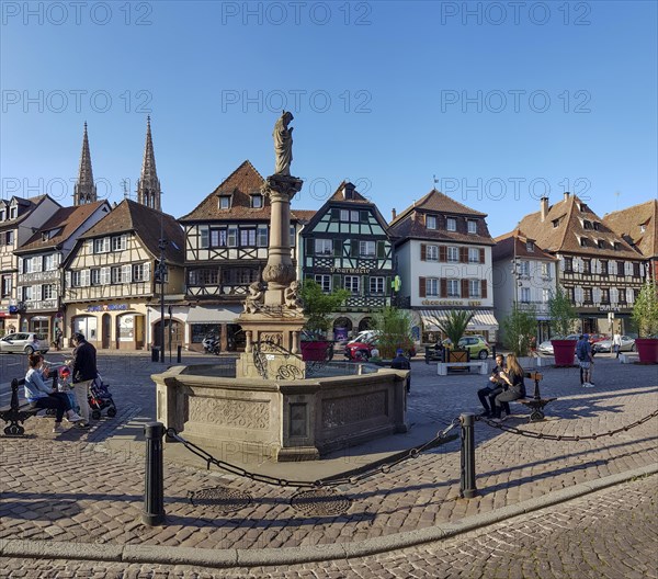 Sainte-Odile fountain on the Pl. Beffroi square and half-timbered houses in the background