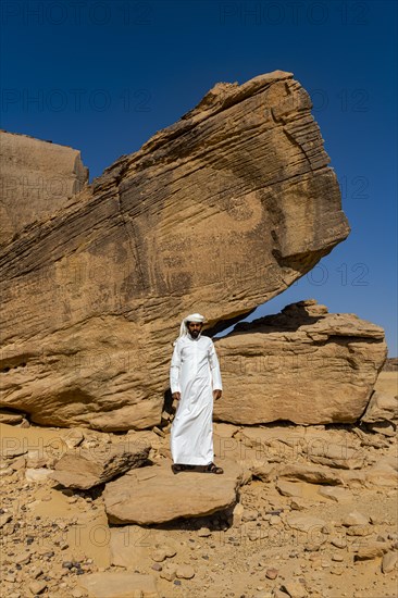 Man pointing at rock carvings