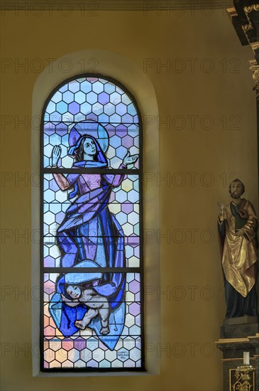 Coloured stained glass window with figures of saints in the Church of Our Lady Mariae Namen