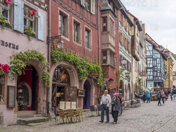 Colourful half-timbered houses and tourists in Rue du General du Gaulle