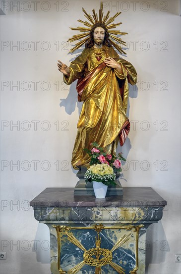 Christ figure with flower decoration