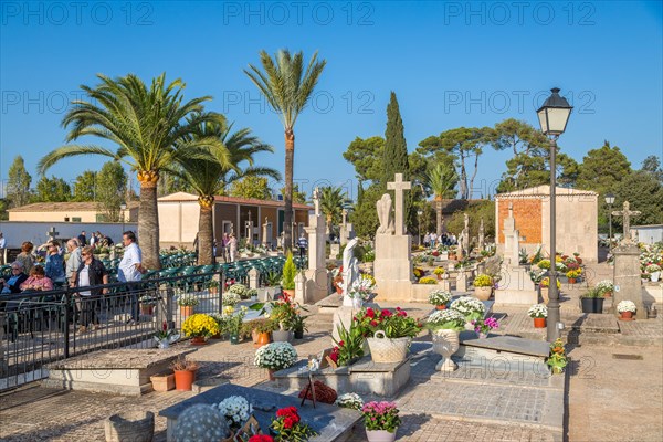 Open-air service and decorated graves on All Saints' Day at Llubi Cemetery