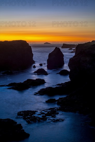 Sea stacks and cliffs at sunset at Eshaness