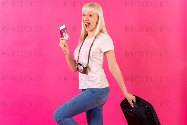 Very happy smiling tourist with passport and suitcase