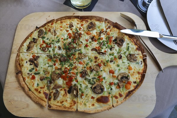 Flammkuchen on wooden board