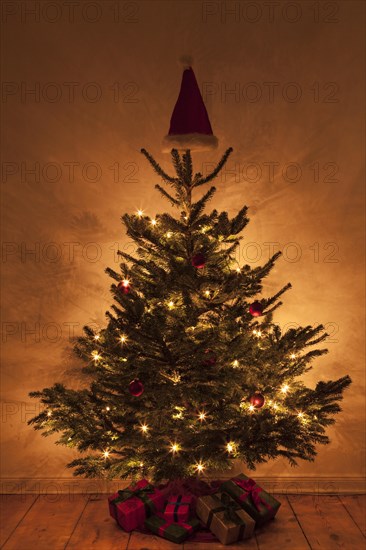 Christmas tree with a Christmas hat on the top of the tree