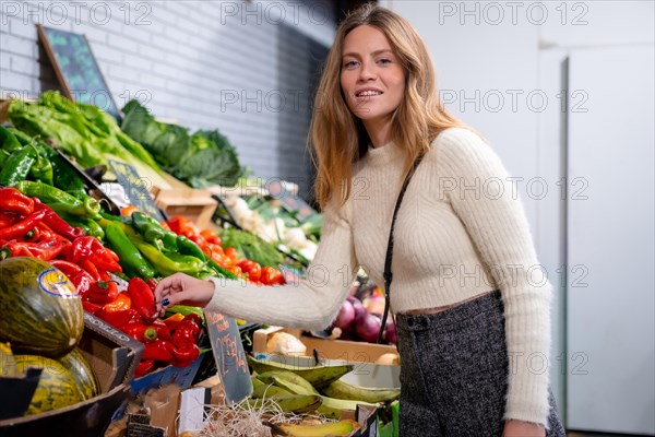 Portrait of a caucasian woman buying vegetables and greens in the grocery store