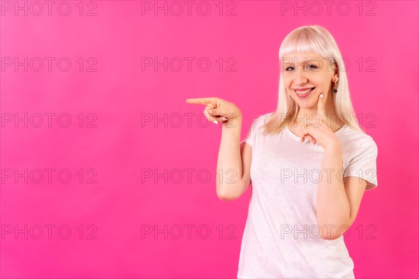 Blonde caucasian girl studio shot on pink background