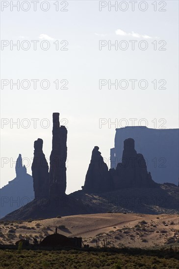 The rock formation Totem Pole with Navajo settlement