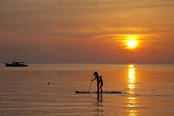 Mother and child standup paddleboarding