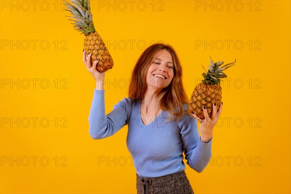 Vegetarian woman with a pineapple in sunglasses