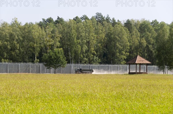View of the border fence to Belarus with truck on the Polish side