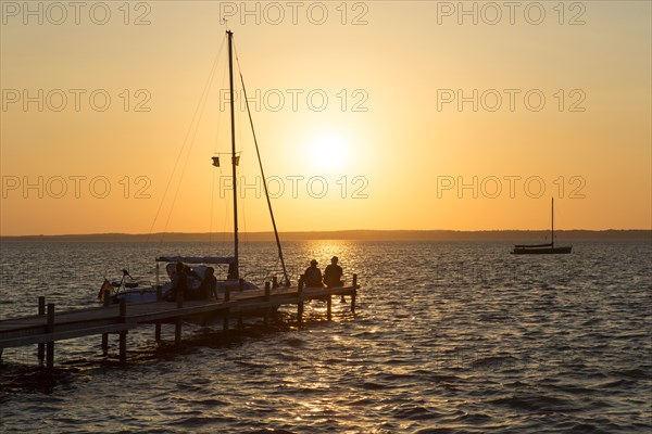 Couple sitting on jetty at Lake Steinhude