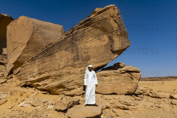 Man pointing at rock carvings