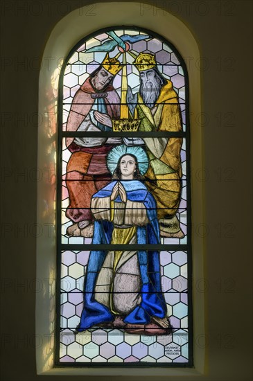 Coloured stained glass window with figures of saints in the Church of Our Lady Mariae Namen