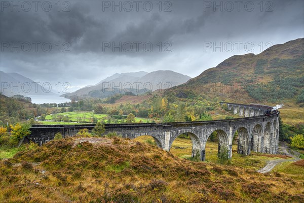 Glenfinnan Viaduct with steam locomotive in autumn
