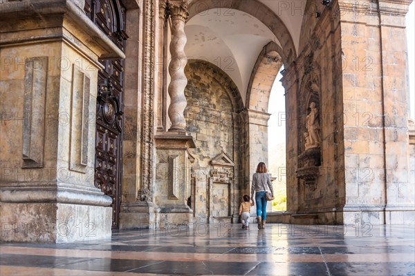 Mother and son in the arches of the entrance of the Sanctuary of Loyola