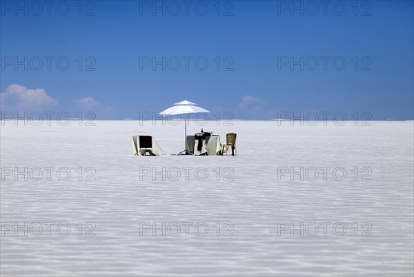 Parasol and chairs on the Salar de Uyuni