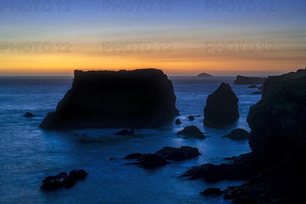 Sea stacks and cliffs at sunset at Eshaness