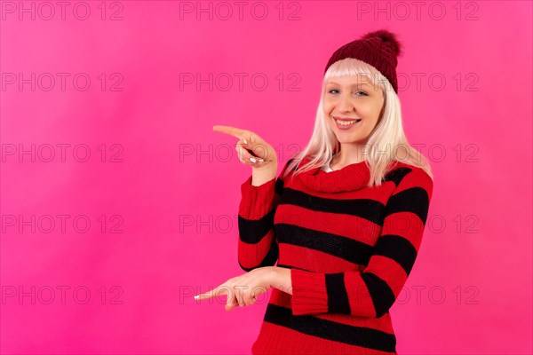 Blonde caucasian girl on pink background studio