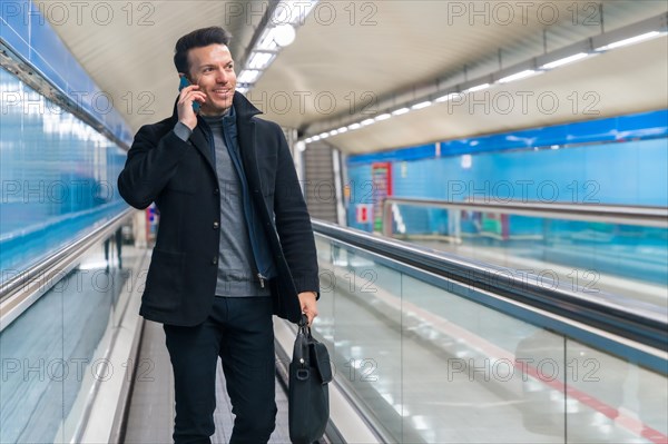 Middle-aged Caucasian businessman walking on the moving treadmill on the subway going to work