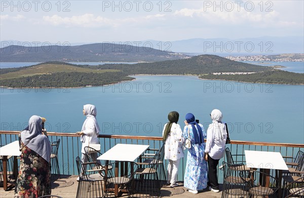 Turkish woman in headscarves look from Satan's Table at Ayvalik Islands National Park in the Aegean Sea