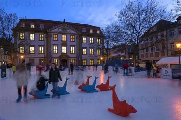 Ice skating rink in colourful evening lighting