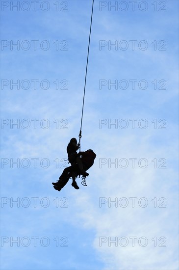 Silhouette of rescuer and climber