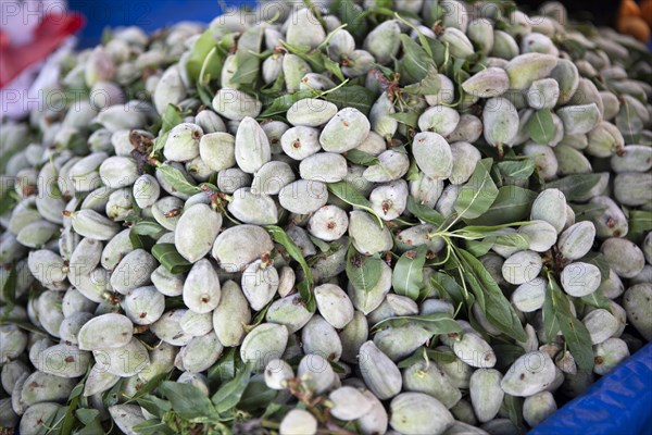 Green almonds at the weekly market market of Cunda