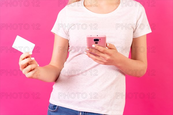 Blonde caucasian girl in pink studio background