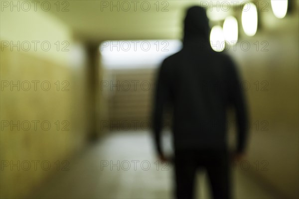 Blurred person standing in a tunnel