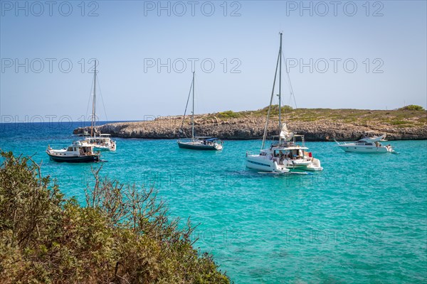 Sailing boats and catamaran in Cala Varques bay
