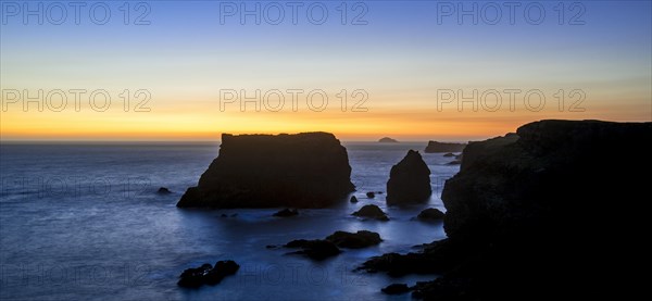 Sea stacks and cliffs at sunset at Eshaness