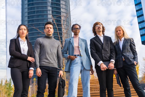 Corporate portrait of group of multi-ethnic businessmen and businesswomen outside offices