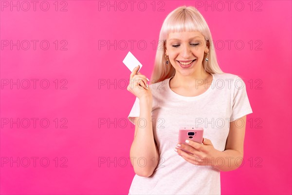 Blonde caucasian girl in pink studio background