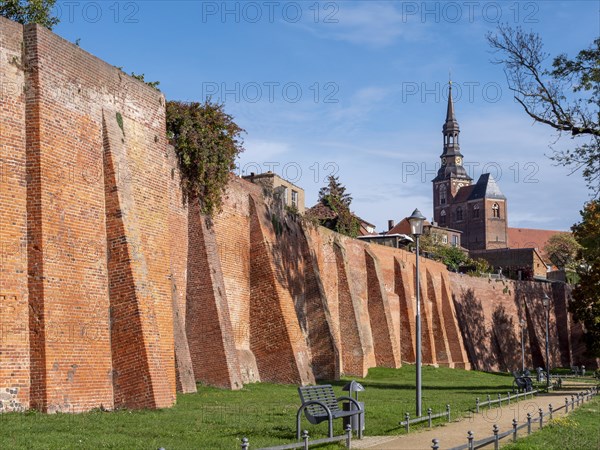 Brick city wall and in the background the Protestant Church of St. Stephan