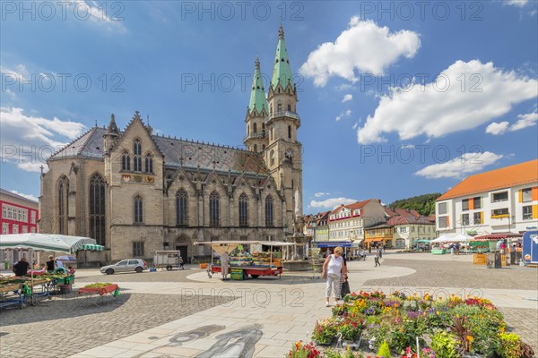 Weekly market at the market with the town church of Our Lady