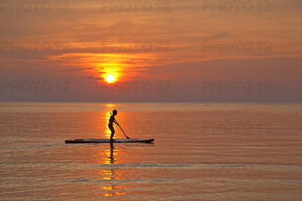 Child standup paddleboarding