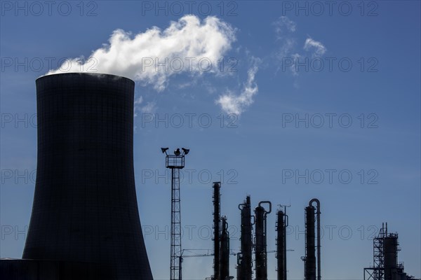 Silhouette of industrial estate showing cooling tower of the BASF chemical production site in the port of Antwerp