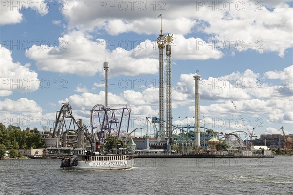 Ferry in the harbour and rides at Tivoli Groena Lund amusement park on the Djurgarden peninsula